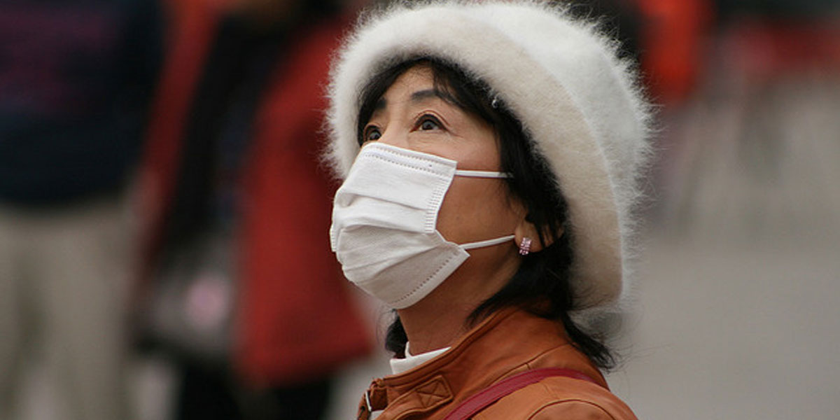 Woman in China wears face mask as protection against pollution in the air. [(CC BY-SA 2.0): Nicolò Lazzati]